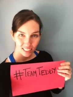 me holding a team teddy sign