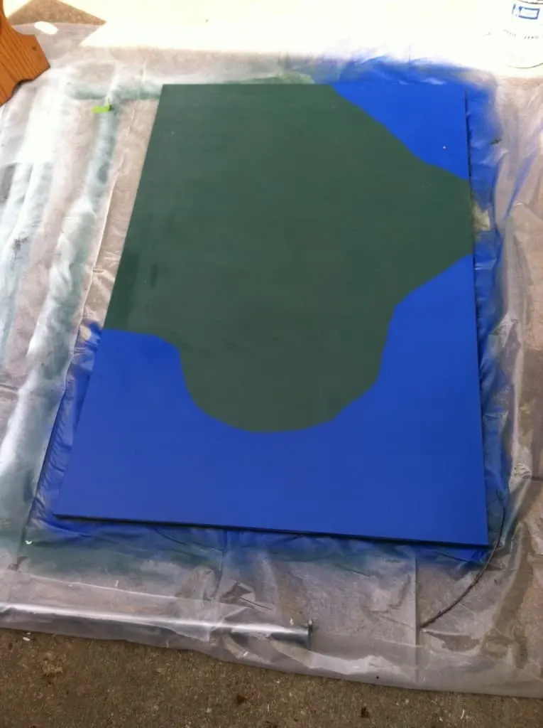 the lake and grass painted on the train table top
