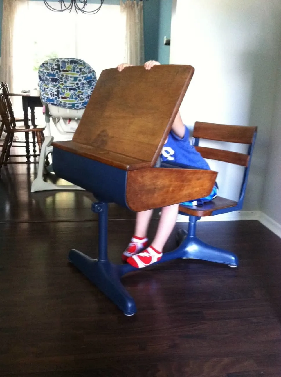 my son playing with his new desk
