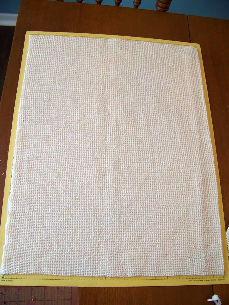 diy dishtowel fabric laid out on fabric cutting mat