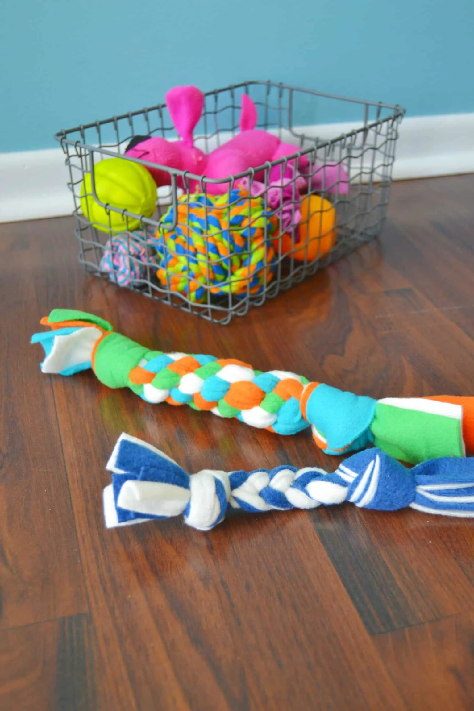 diy fleece dog toys in front of a basket of other dog toys