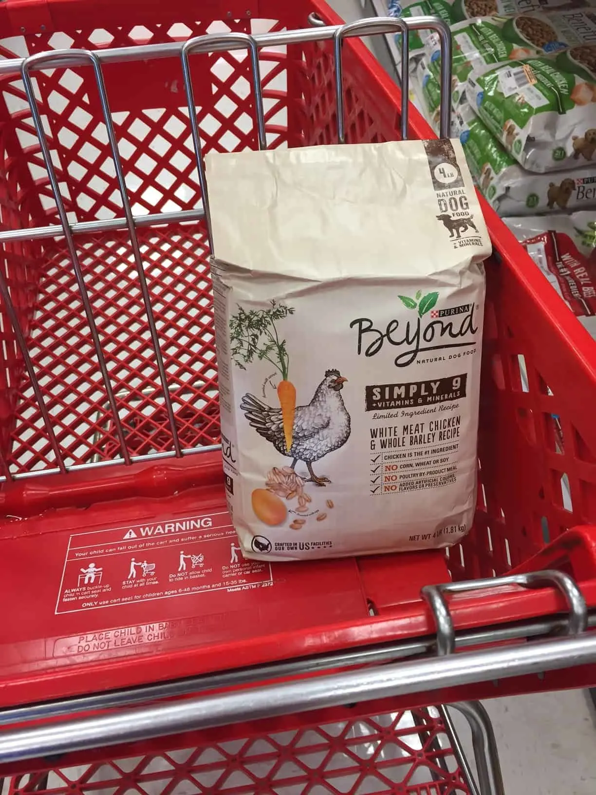 a bag of dog food in a grocery cart