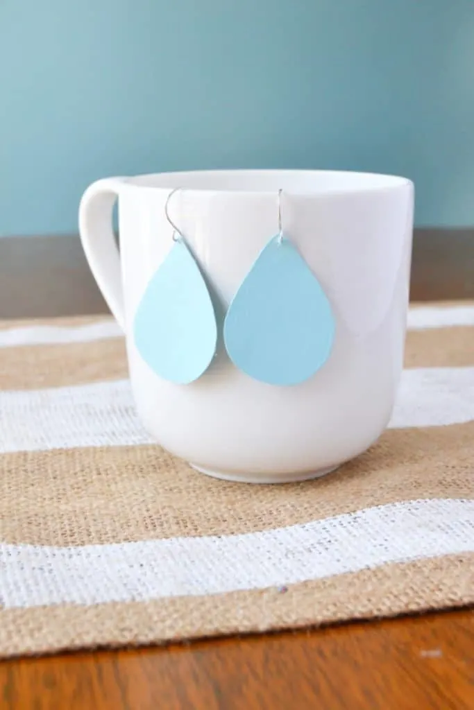 upcycled earrings on a cup