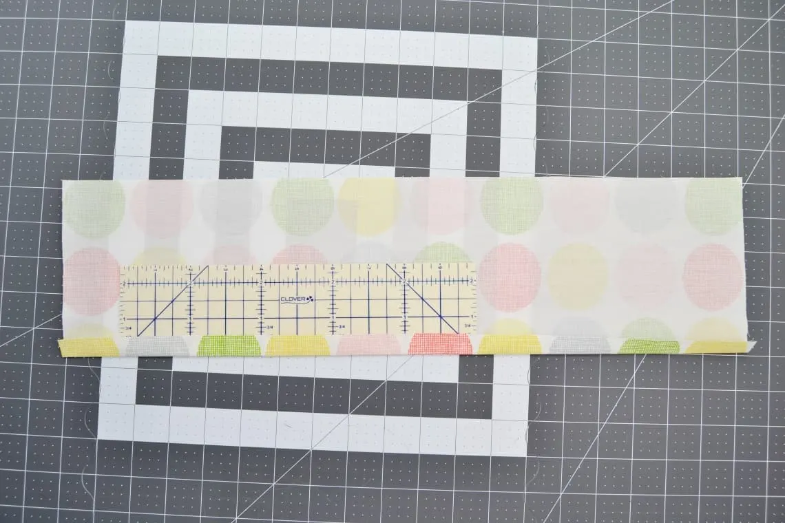 using the hemming ruler to press each side over half an inch