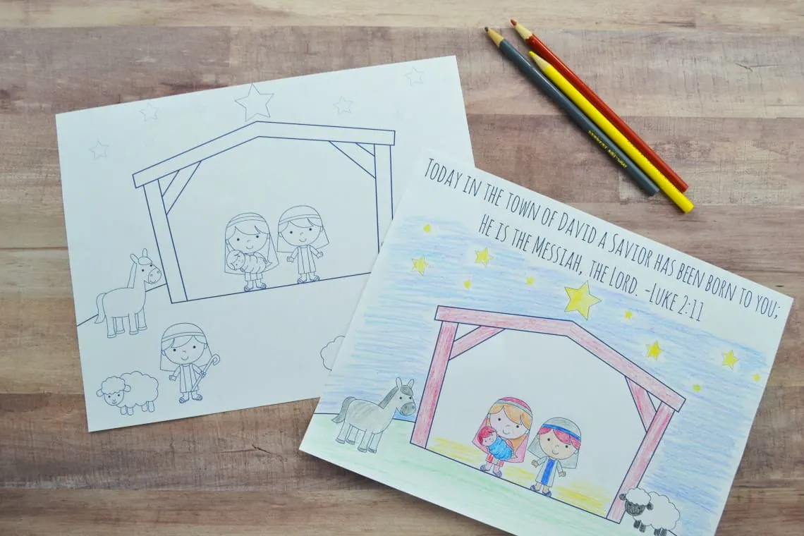 Nativity coloring pages sitting on the table with some colored pencils