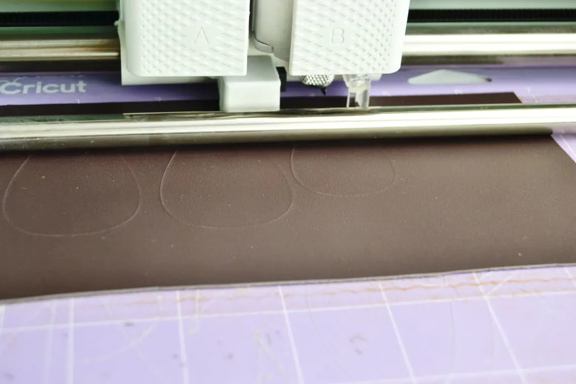 the Cricut Maker cutting the leather