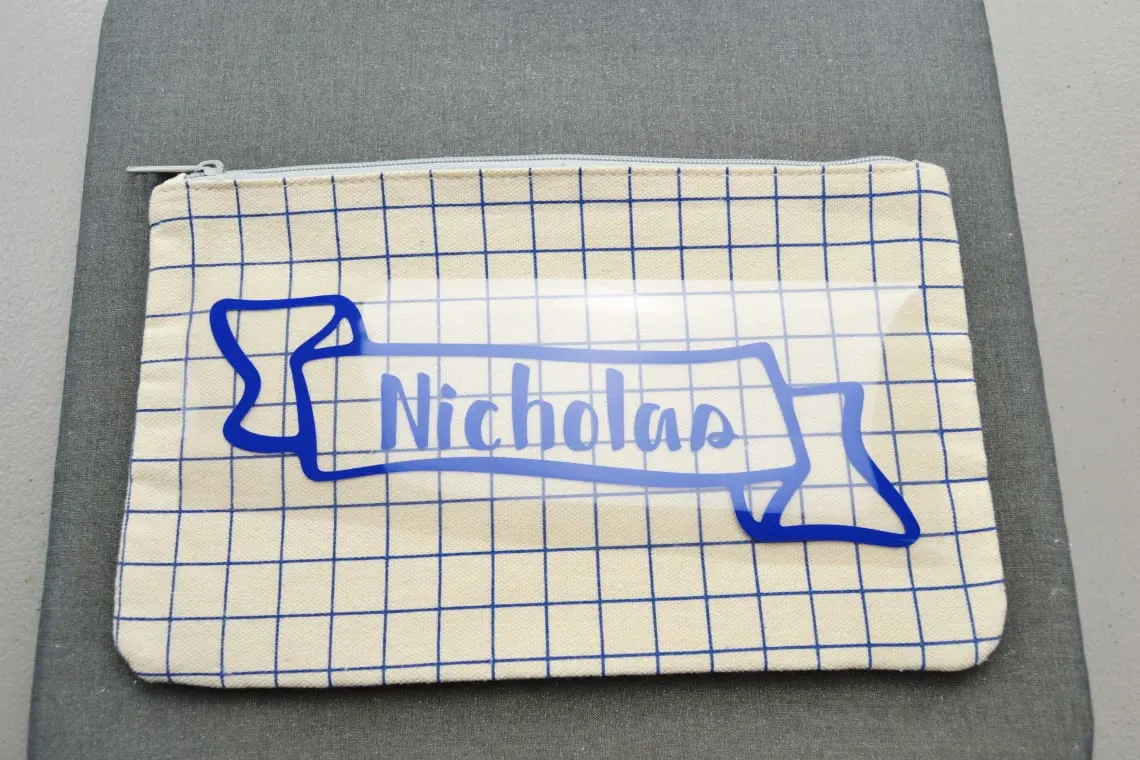 the iron-on vinyl placed on the top of the pencil pouch