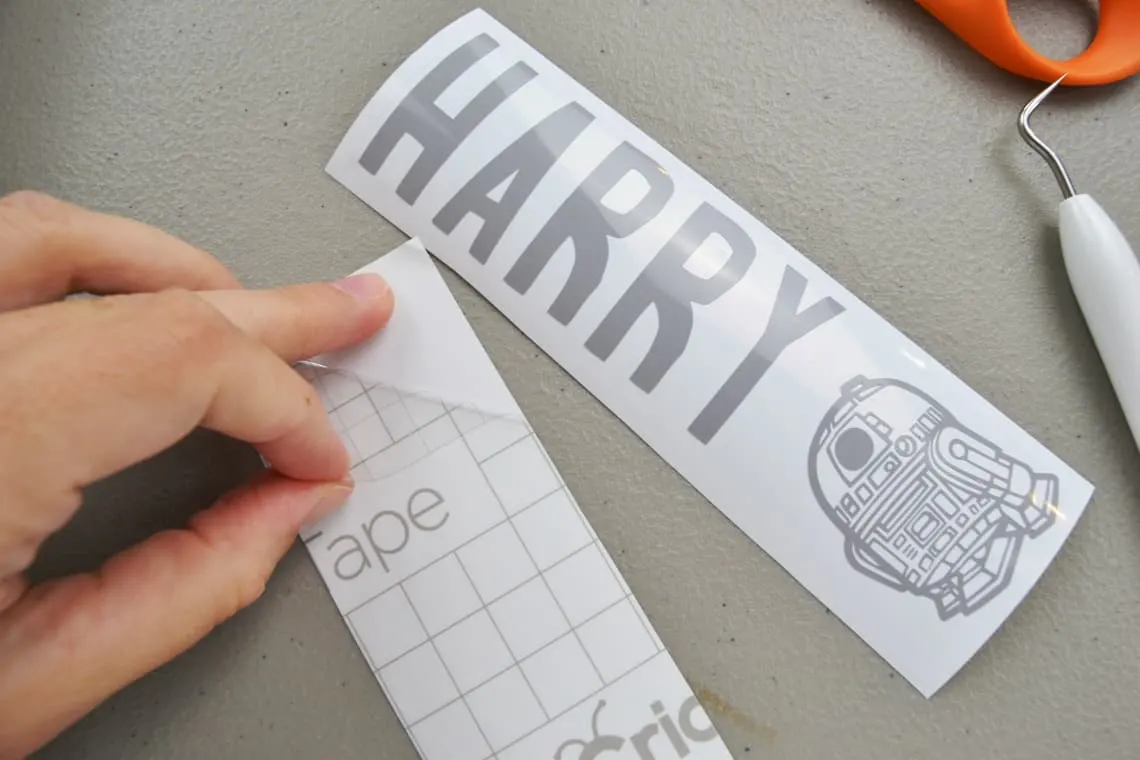 peeling the transfer tape off of the paper backing