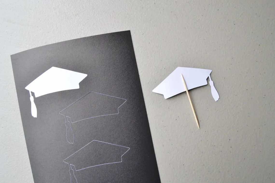 Making the cupcake topper- the first sticker with the toothpick placed on top