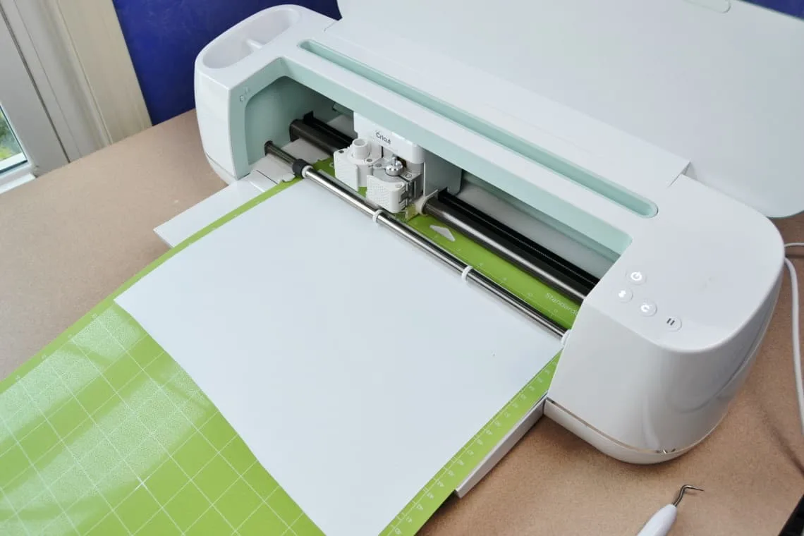 the vinyl shiny side down on the mat and loading it into the machine
