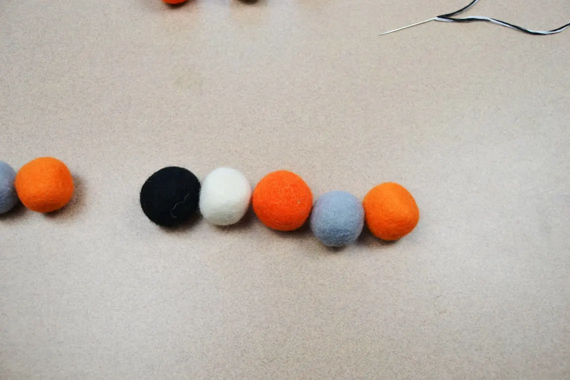 lining up the felt wool balls to decide on a pattern