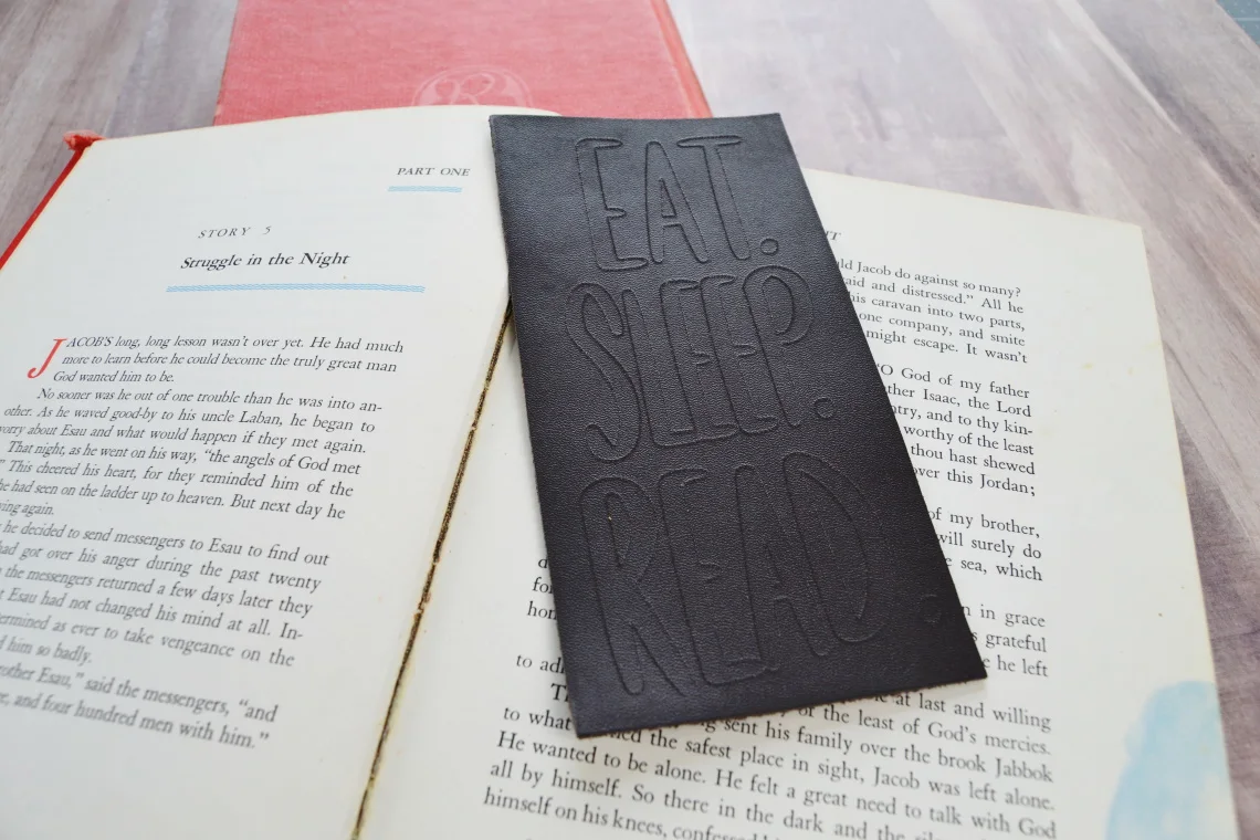 engraved leather bookmarks sitting on a book