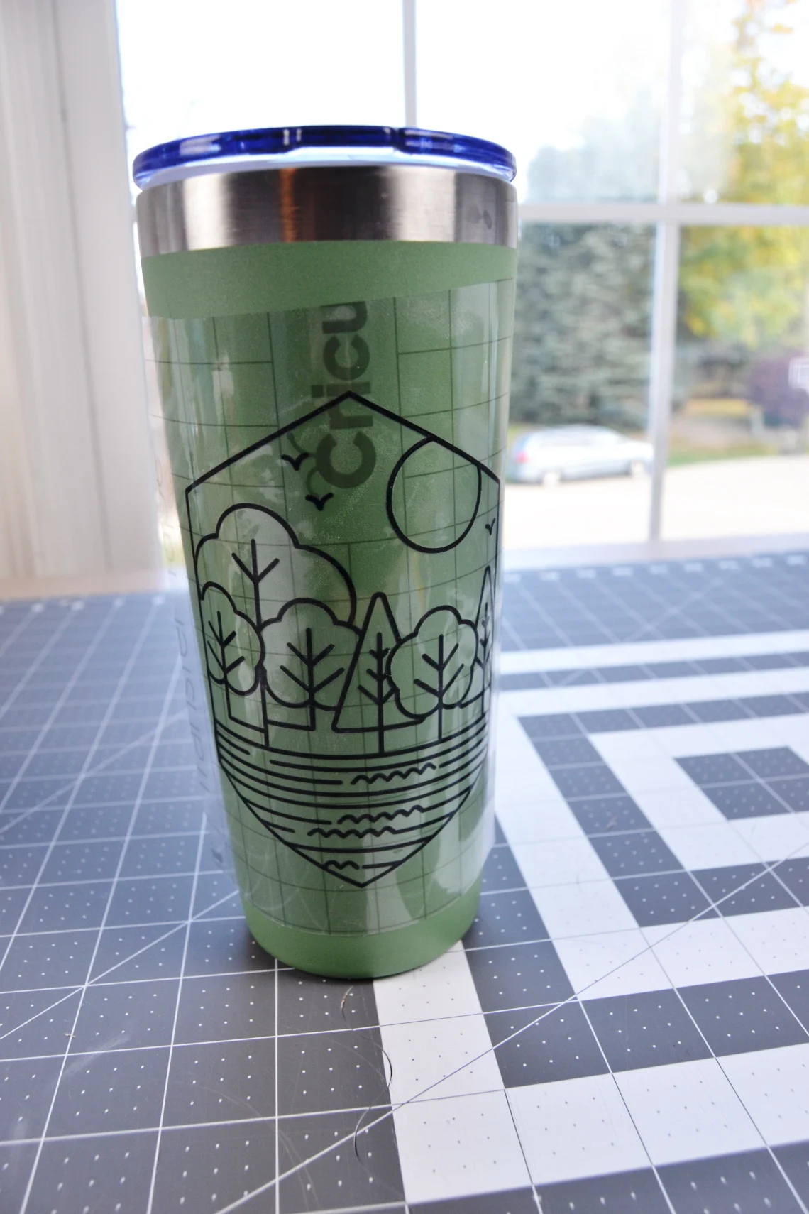 the transfer tape applying the vinyl to the cup