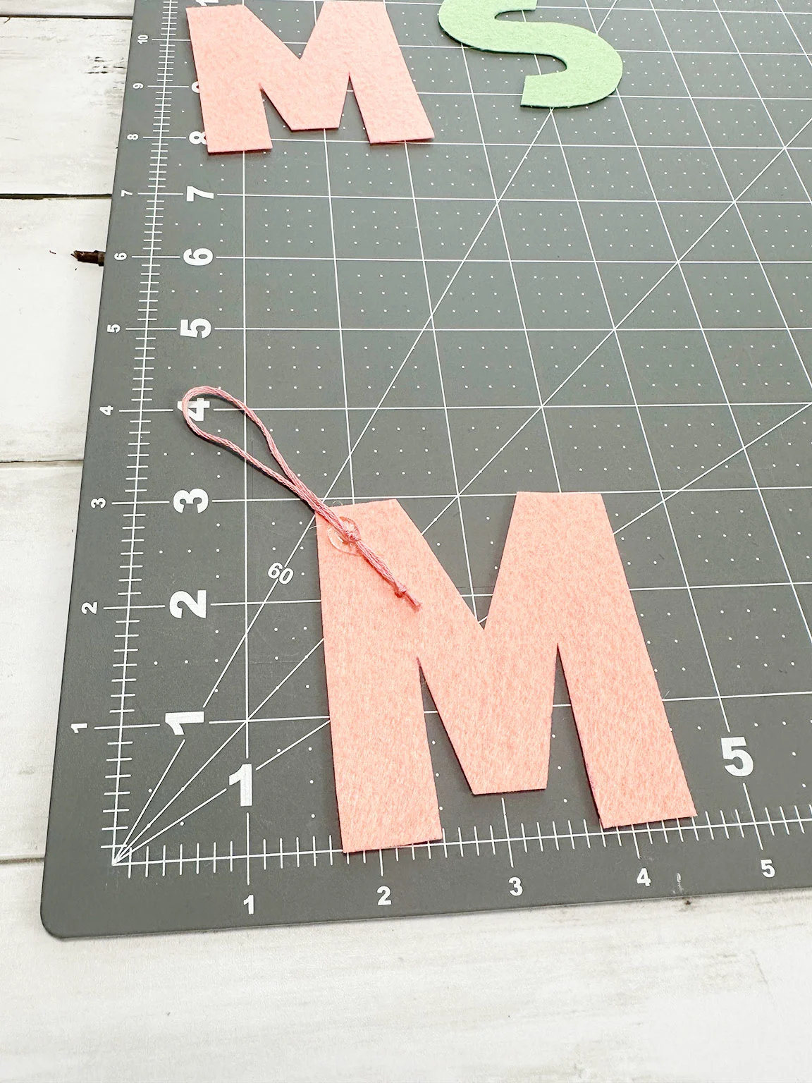 gluing down the embroidery floss