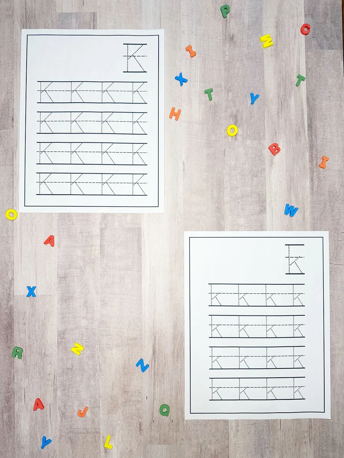 a wooden table with tracing worksheets on it