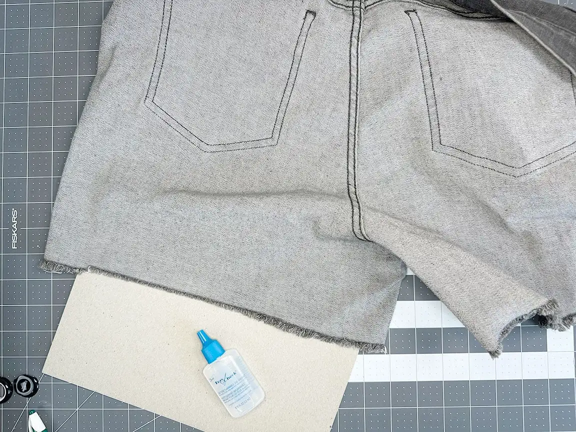 cardboard inside of jeans leg of raw hem jeans