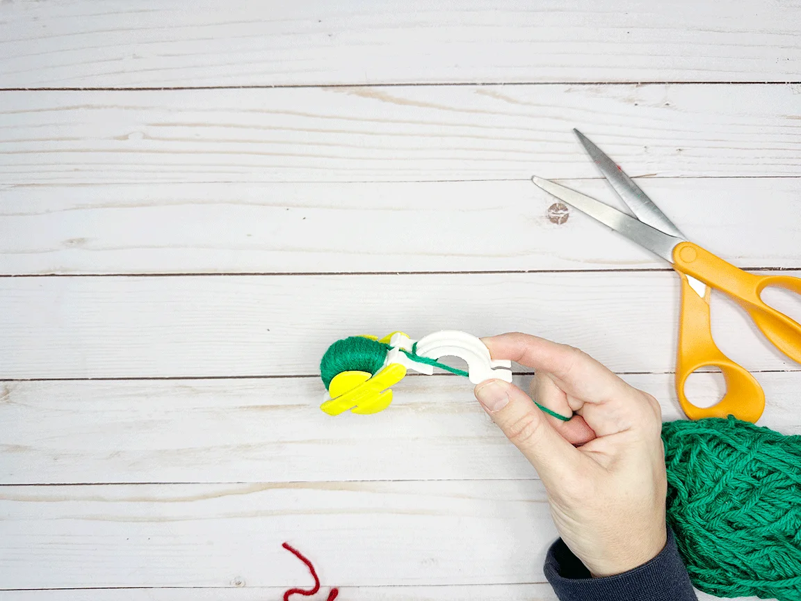 Beginning to wrap the second side of the Pom Pom maker