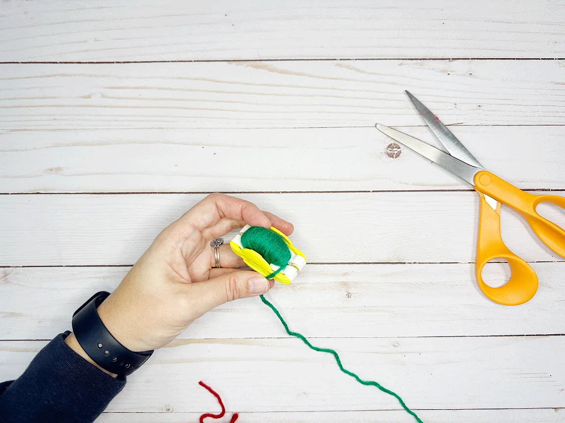 The closed Pom Pom maker fully wrapped in yarn