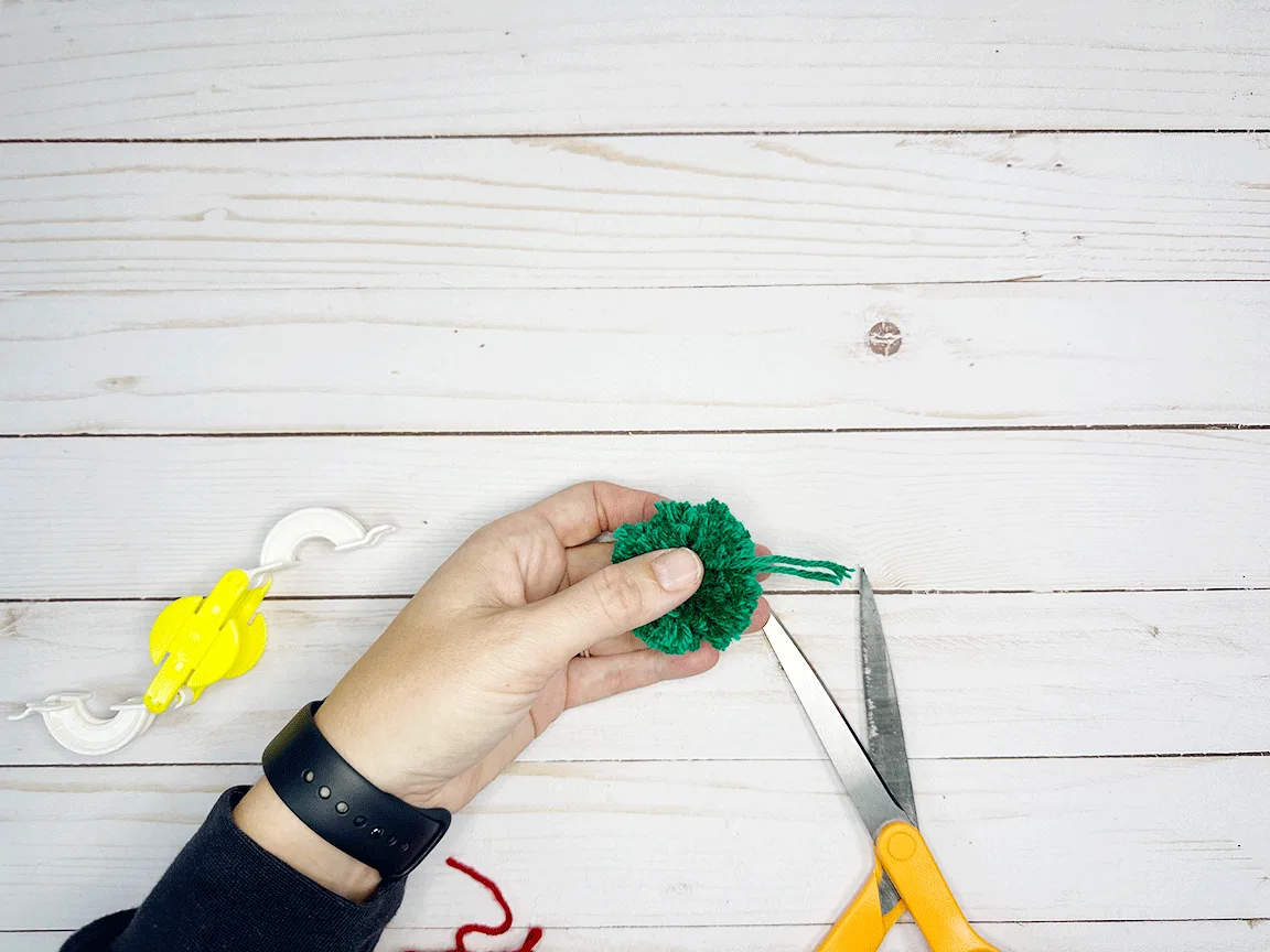 The longer strings on the finished Pom Pom that have to be trimmed at the end